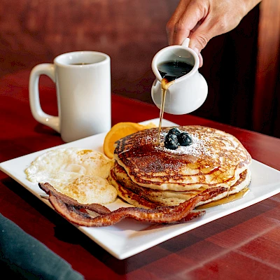 Pancakes, eggs, bacon, and coffee